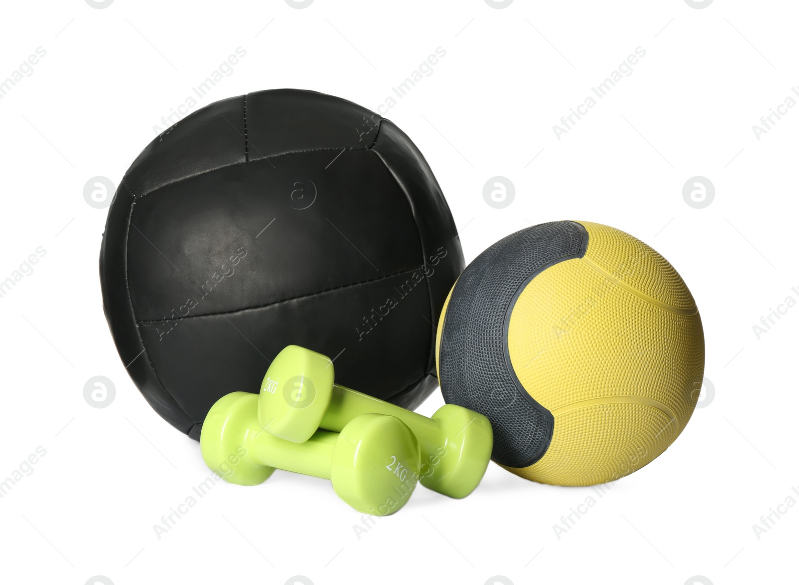 Photo of Medicine balls and dumbbells on white background