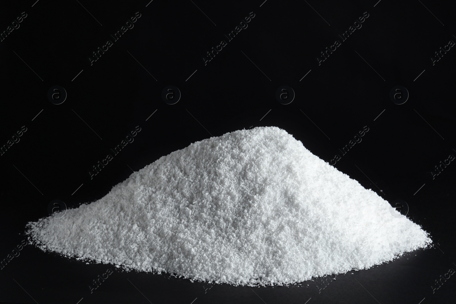 Photo of Heap of white snow on black background