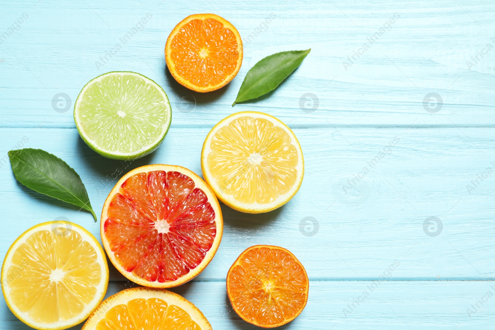 Photo of Flat lay composition with different citrus fruits and space for text on wooden background