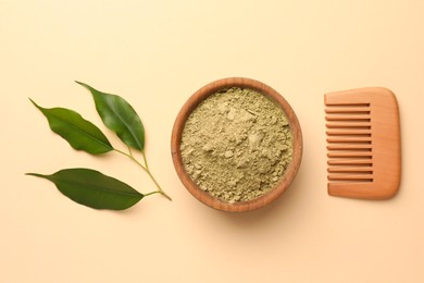 Photo of Henna powder, green leaves and comb on beige background, flat lay. Natural hair coloring