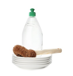 Photo of Cleaning supplies for dish washing and plates on white background