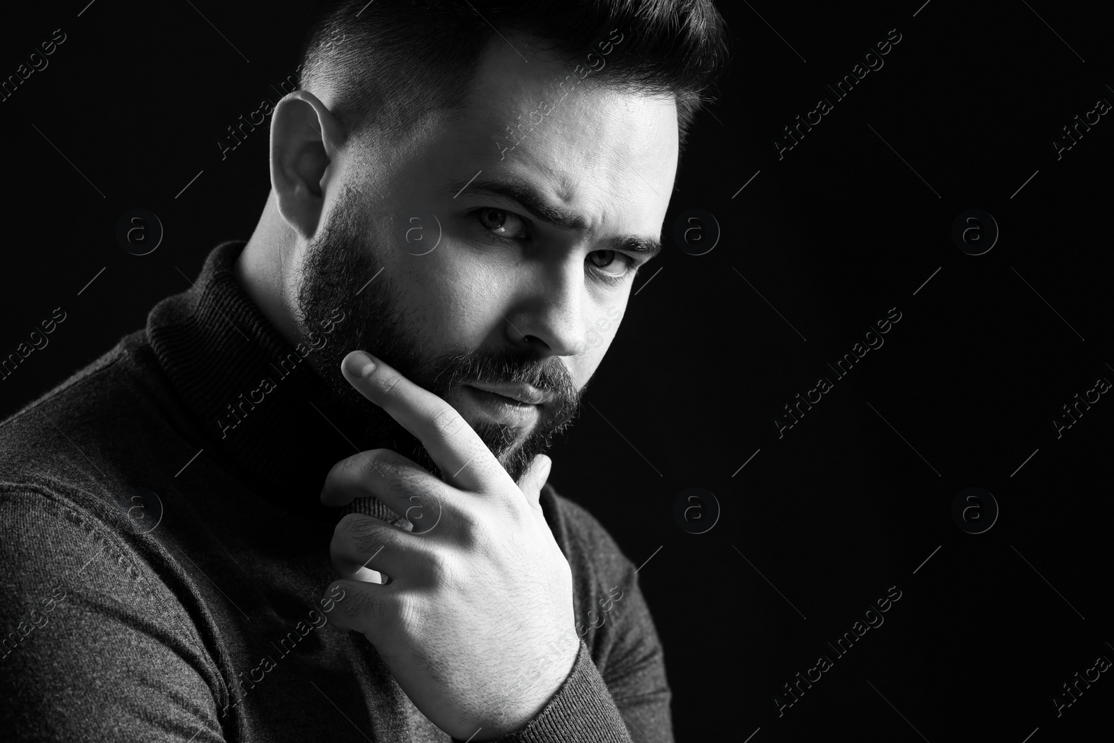 Photo of Portrait of handsome bearded man on dark background, space for text. Black and white effect