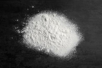 Scattered wheat flour on gray background, top view