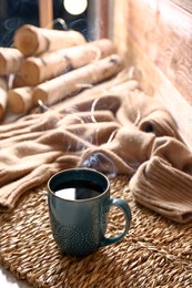 Wicker mat with freshly brewed tea in room. Cozy home atmosphere
