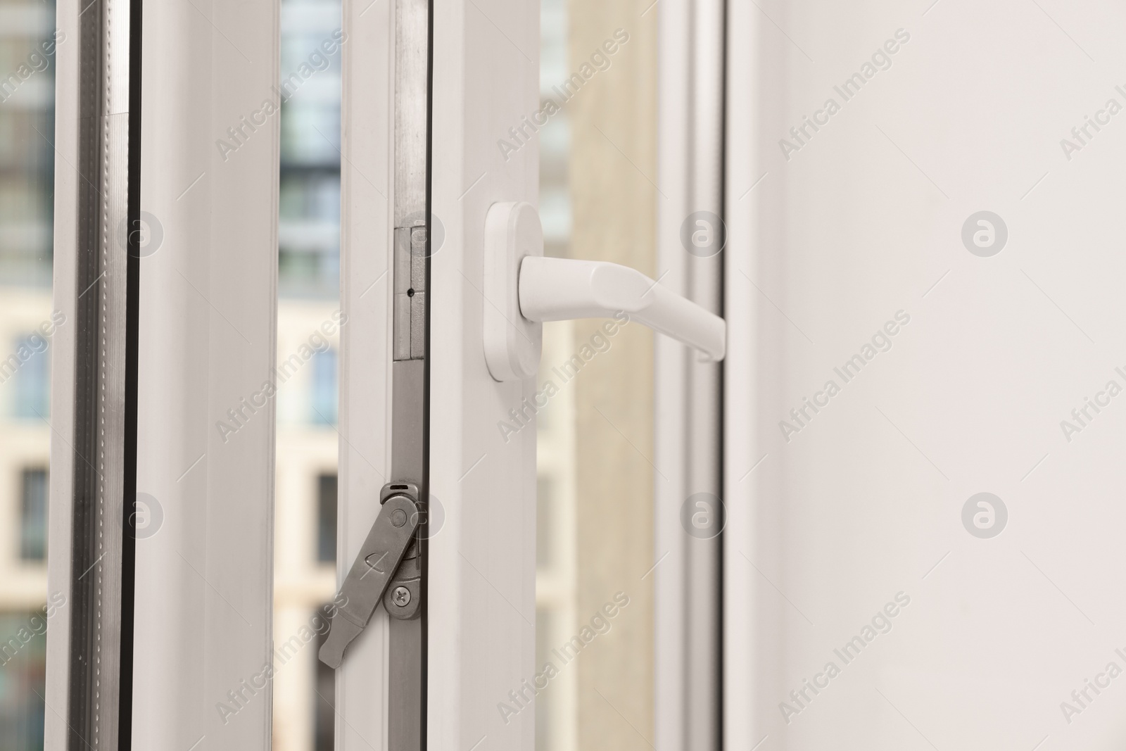 Photo of Open window with white plastic frame indoors, closeup