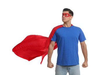 Man wearing superhero cape and mask on white background