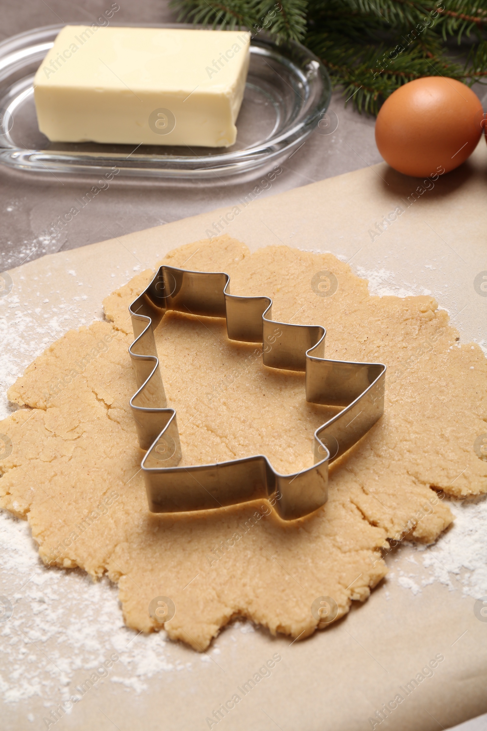 Photo of Making Christmas cookies. Raw dough and cutter on table