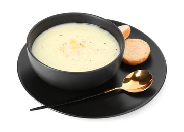 Photo of Bowl of tasty leek soup with bread and spoon isolated on white