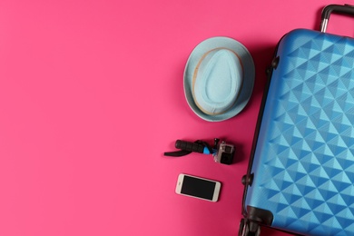 Photo of Flat lay composition with suitcase and traveler's accessories on color background. Space for text