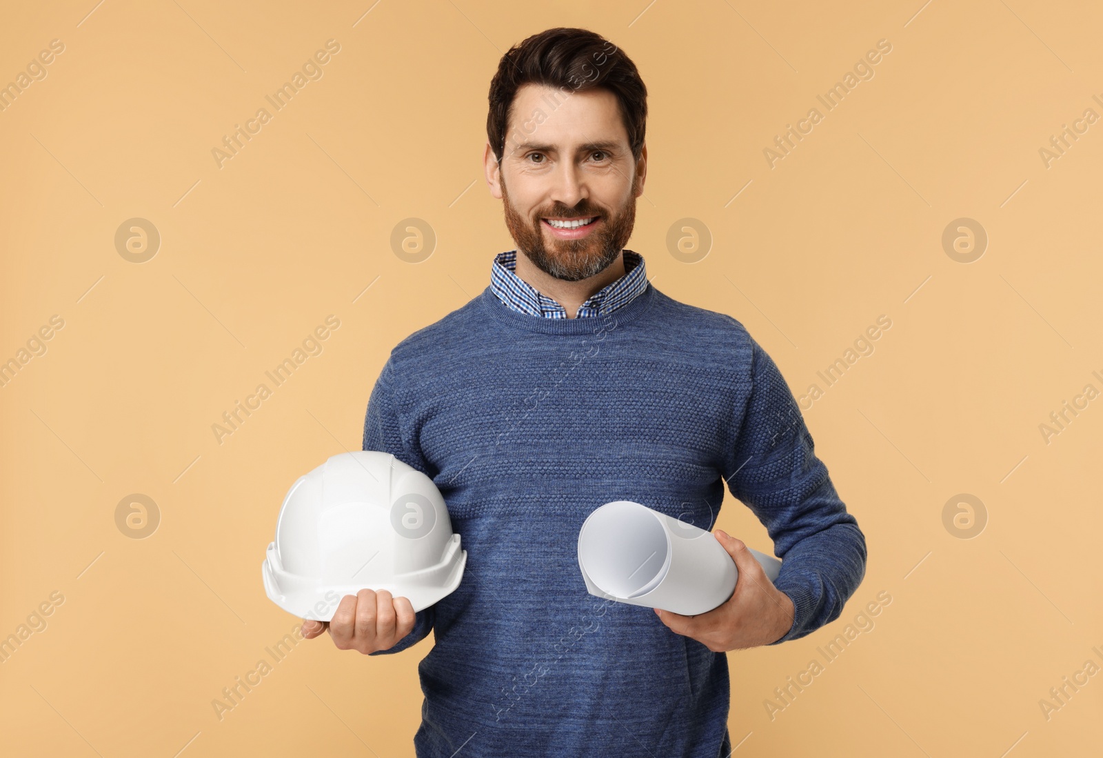 Photo of Architect with hard hat and draft on beige background