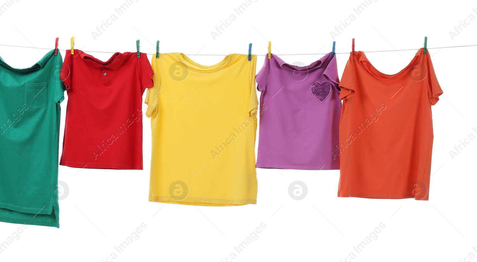 Photo of Colorful t-shirts drying on washing line isolated on white