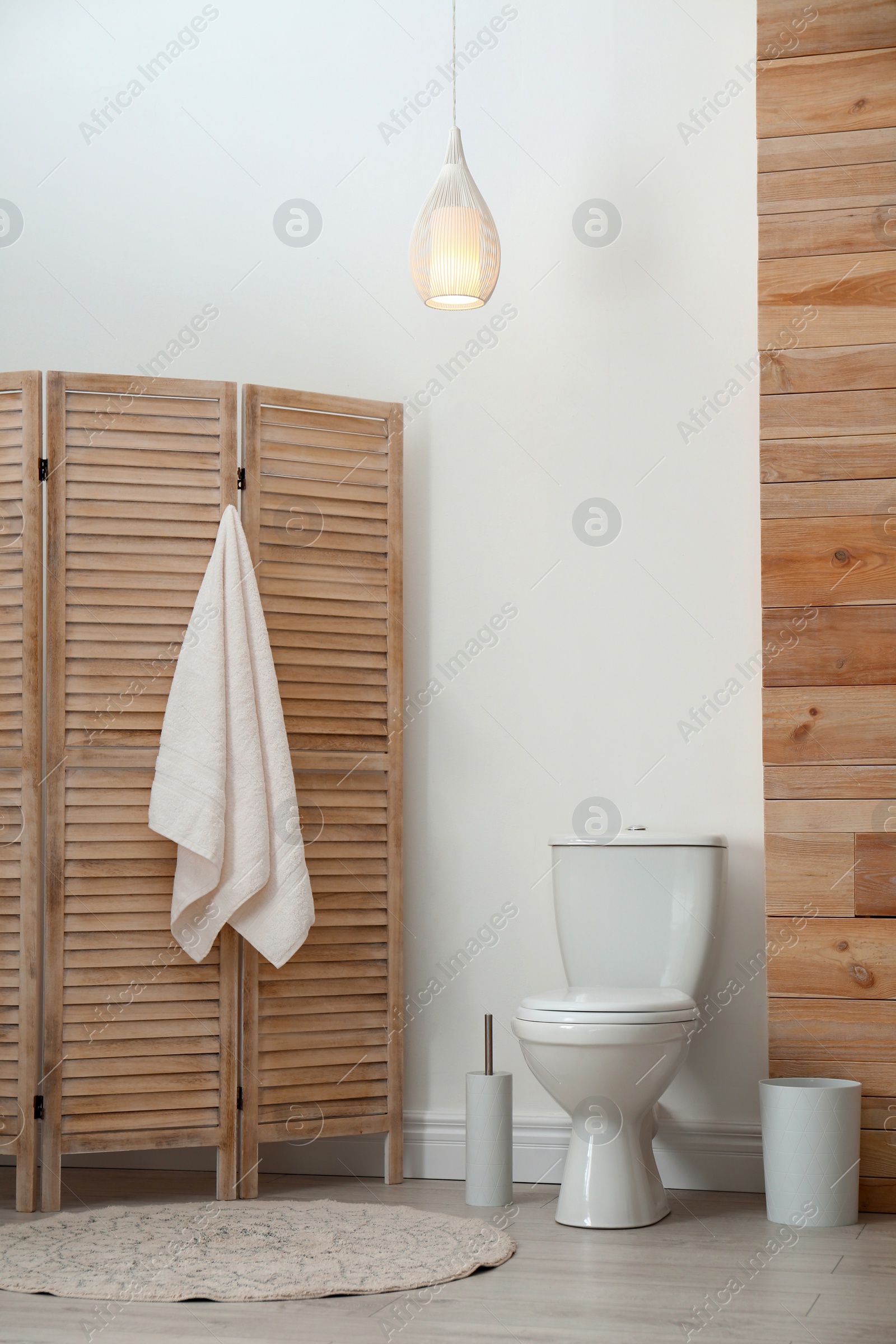 Photo of Toilet bowl near white wall in modern bathroom interior