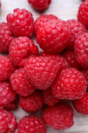 Photo of Tasty ripe raspberries on white table, top view