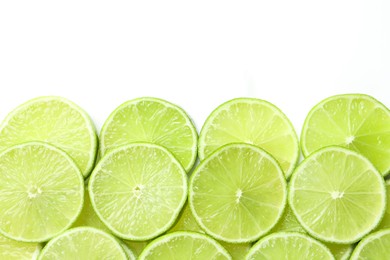Photo of Fresh juicy lime slices on white background, flat lay. Space for text