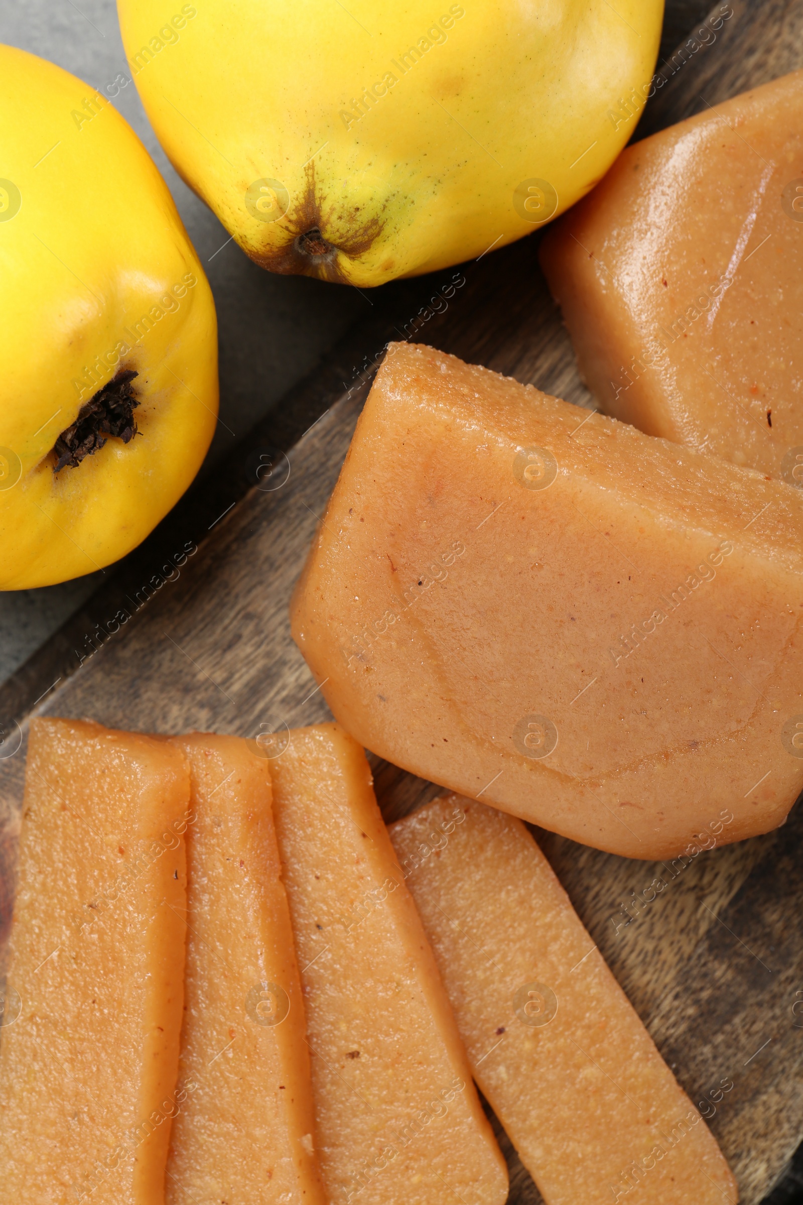 Photo of Tasty sweet quince paste and fresh fruits on grey table, flat lay