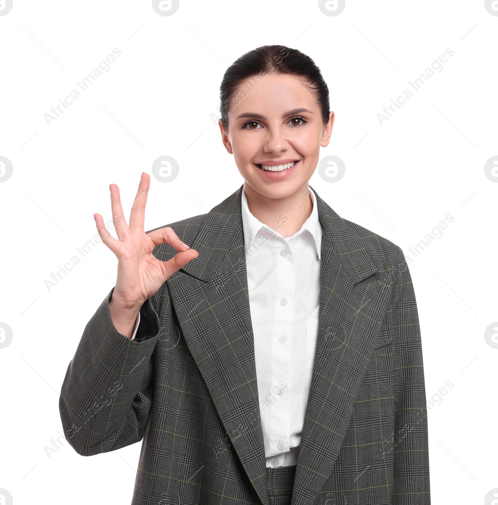 Photo of Beautiful businesswoman in suit showing OK gesture on white background