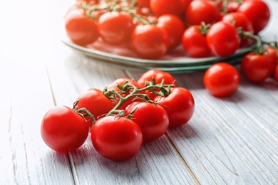 Photo of Fresh ripe red tomatoes on wooden table