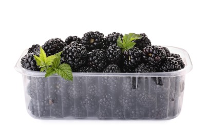 Tasty ripe blackberries in plastic container isolated on white