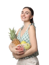 Woman with string bag of fresh fruits on white background