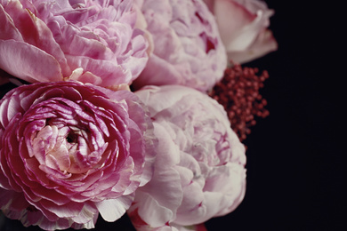 Beautiful bouquet of different flowers on black background, closeup. Floral card design with dark vintage effect