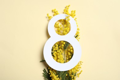 Photo of 8 March greeting card design with mimosa flowers on beige background, top view. Happy International Women's Day