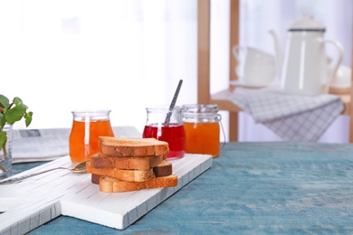 Photo of Toasts with sweet jam on wooden table