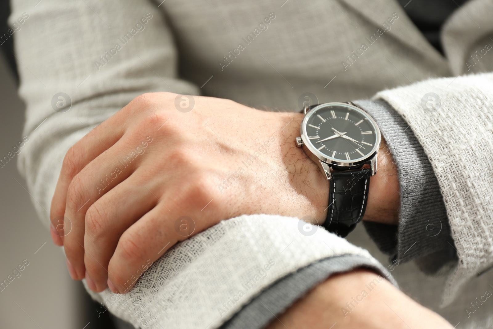 Photo of Businessman in jacket with luxury wrist watch, closeup