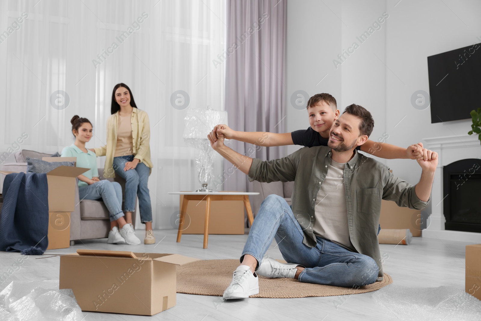 Photo of Happy family spending time in new apartment. Moving day