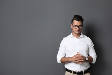 Portrait of handsome young man and space for text on black background