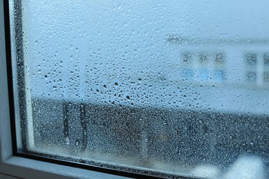 Photo of Window glass with water drops, closeup. Condensation