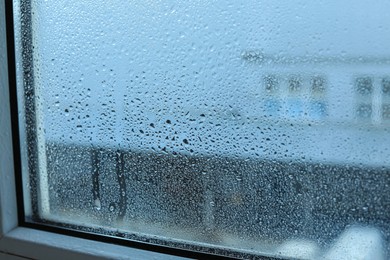 Window glass with water drops, closeup. Condensation