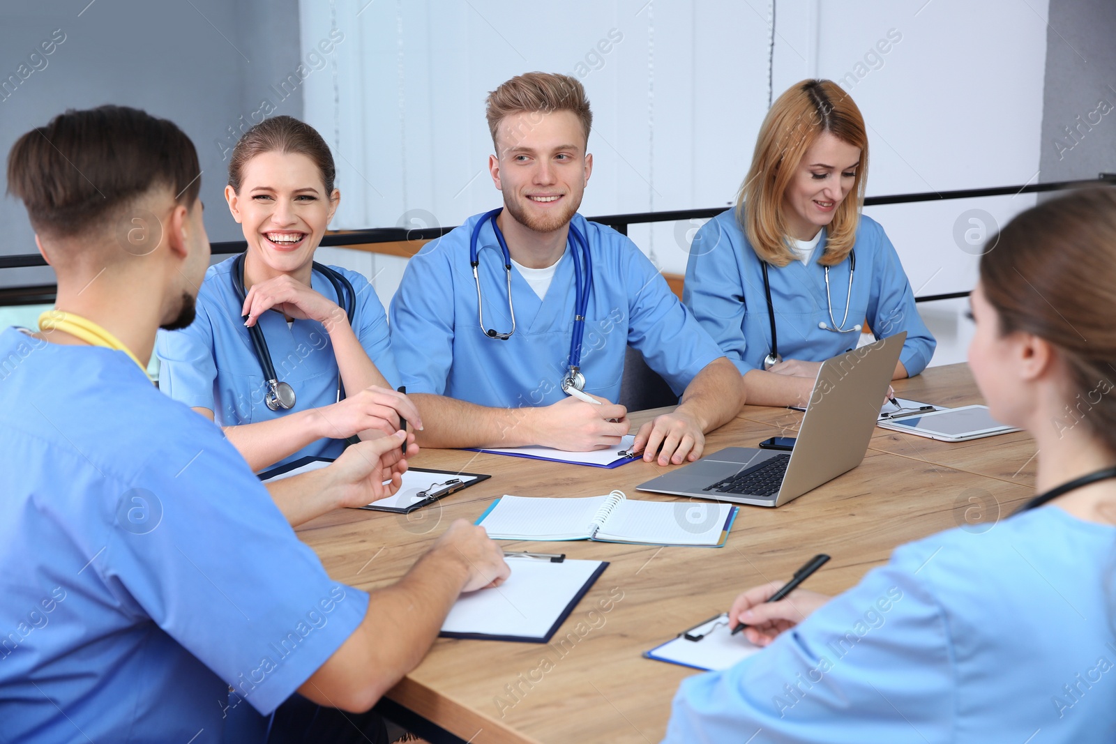 Photo of Medical students in uniforms studying at university