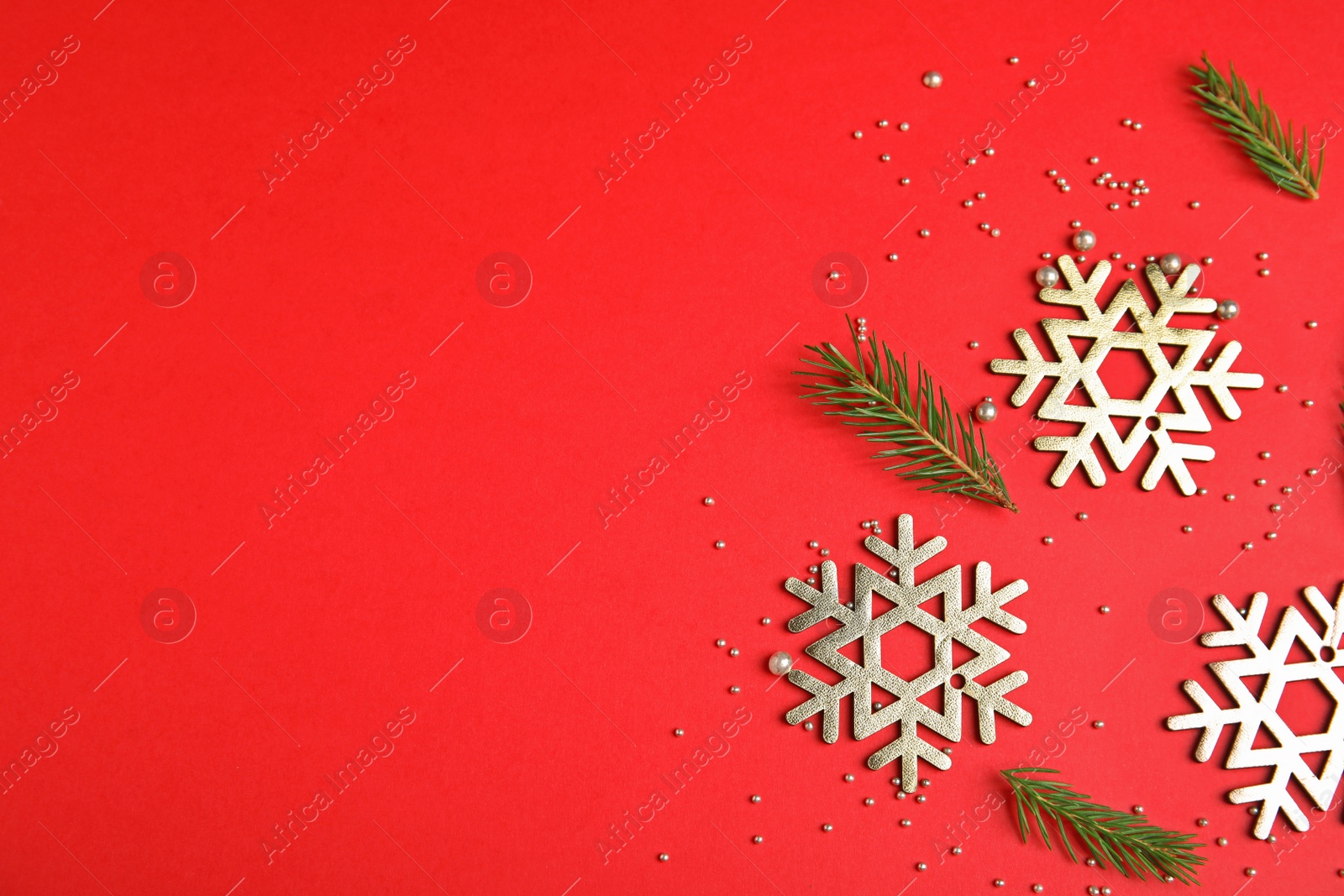 Photo of Flat lay composition with Christmas decor on red background. Space for text