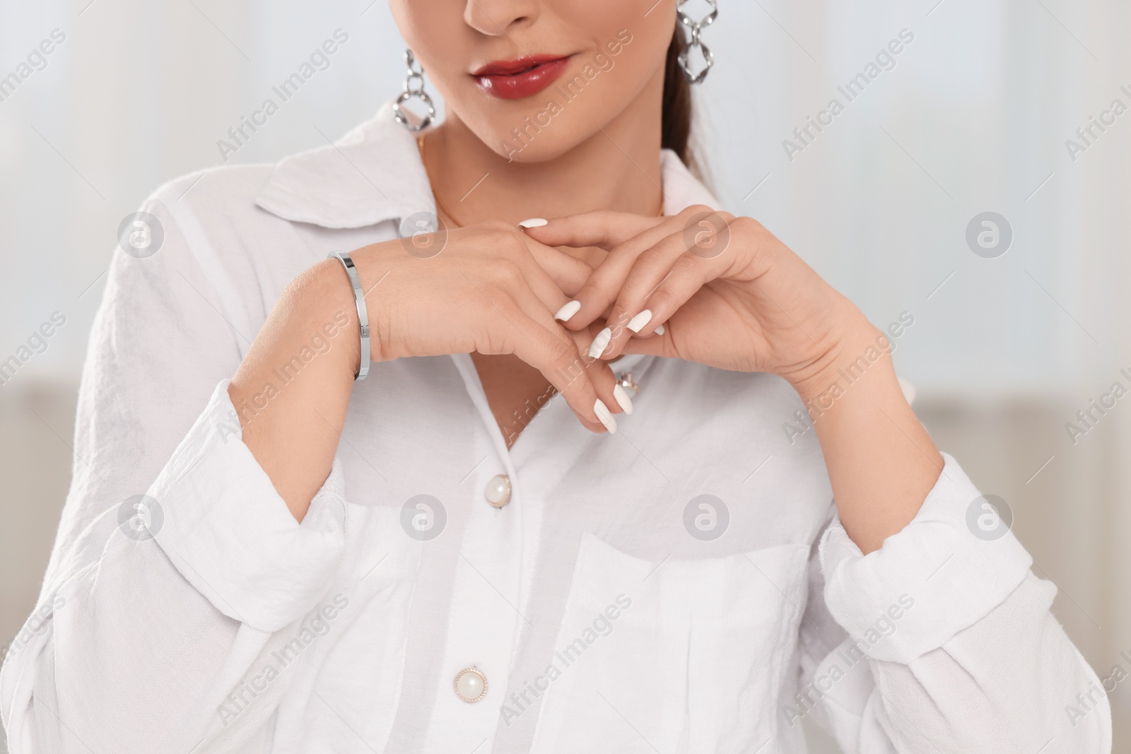 Photo of Beautiful woman with elegant jewelry indoors, closeup