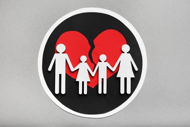 Divorce concept. Broken heart and paper cutout of family on light grey background, flat lay