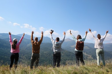 Photo of Grouppeople spending time together in mountains, back view