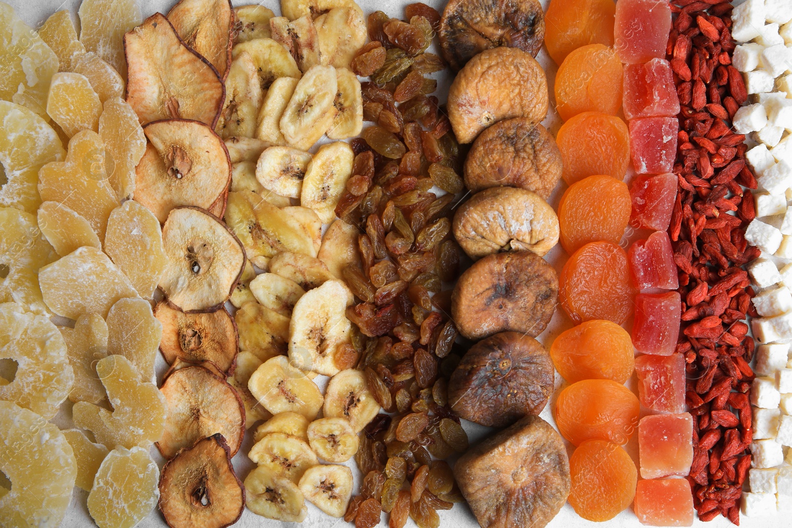 Photo of Different tasty dried fruits as background, top view