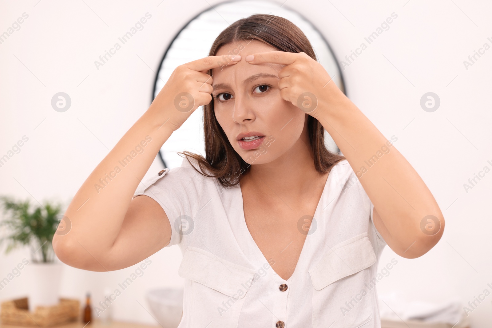 Photo of Woman with skin problem indoors, view from mirror