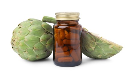 Fresh artichokes and bottle of pills isolated on white