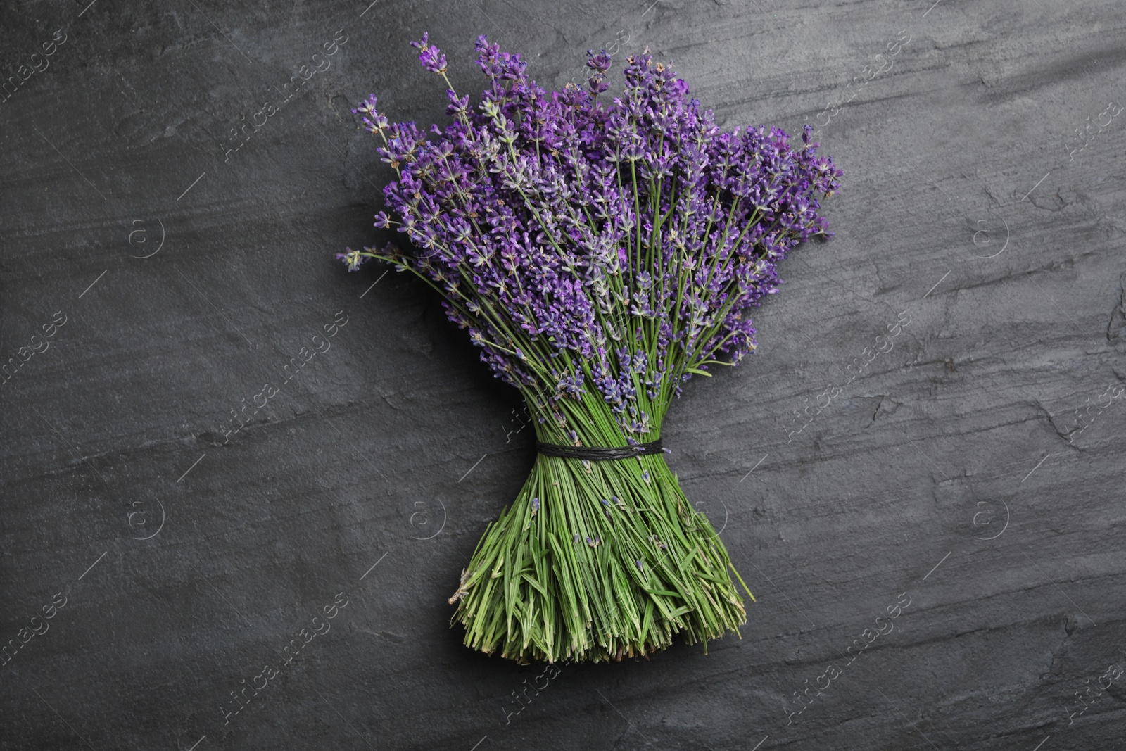 Photo of Beautiful lavender bouquet on black background, top view