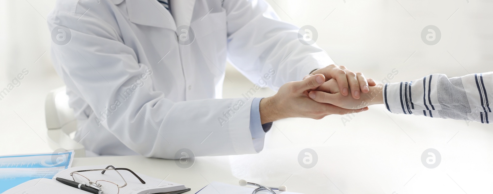 Image of Doctor consulting patient at desk in clinic, closeup. Banner design