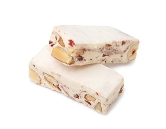 Photo of Pieces of delicious nougat on white background