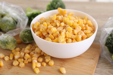 Frozen vegetables on wooden table, closeup view