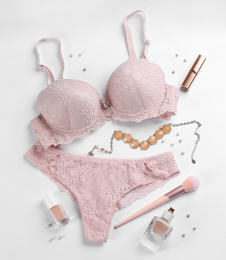 Composition with women's underwear on white background, top view