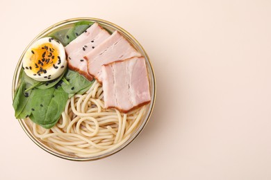 Photo of Delicious ramen with meat on beige background, top view and space for text. Noodle soup