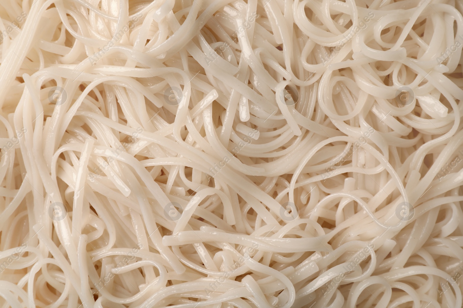 Photo of Delicious rice noodles as background, top view