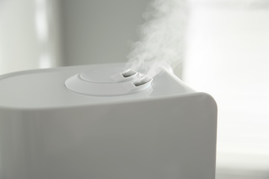 Photo of Modern air humidifier at home, closeup view