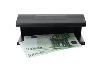 Photo of Modern currency detector with Euro banknotes on white background. Money examination device