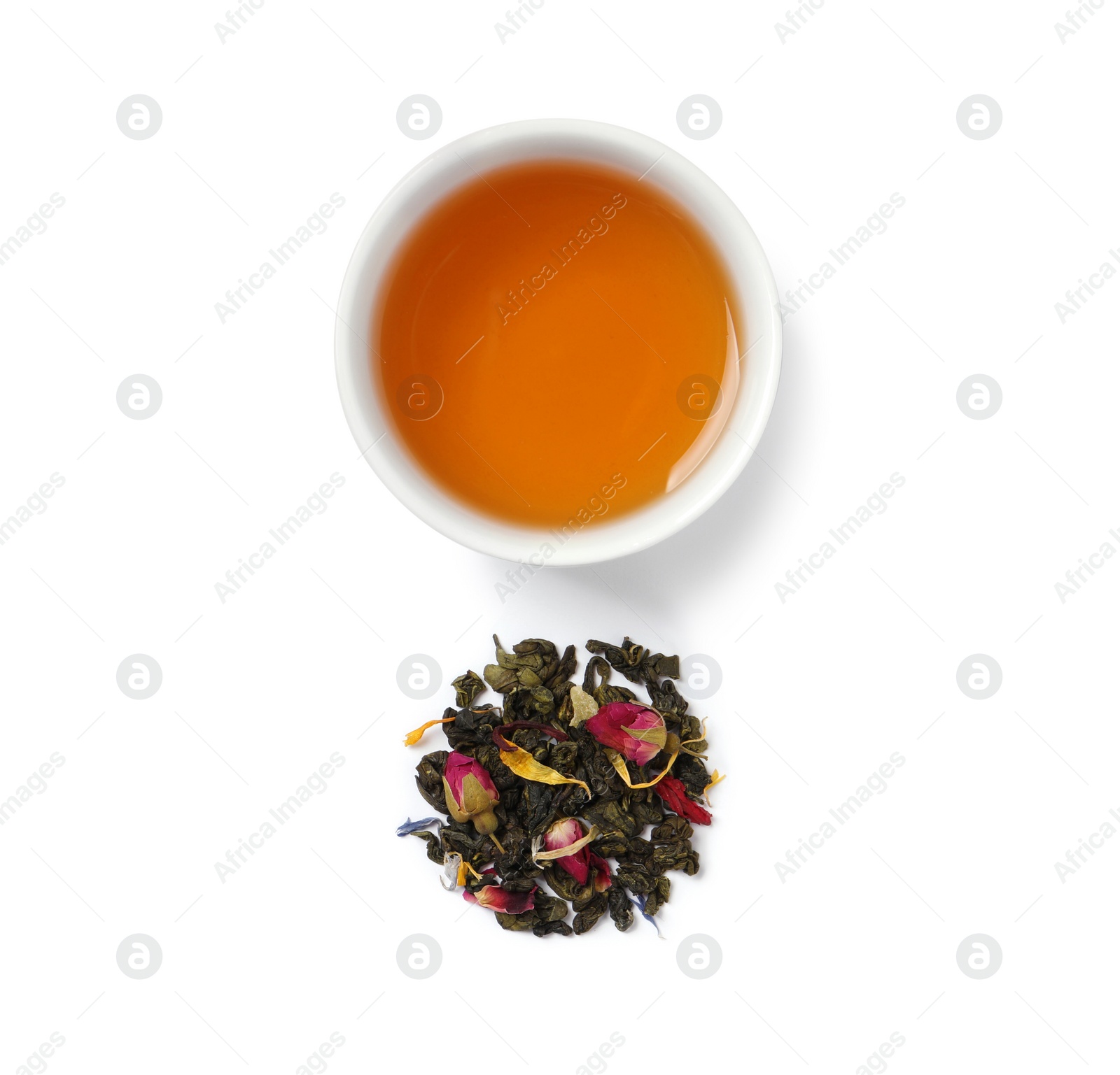 Photo of Hot drink and heap of dry herbal tea on white background, top view
