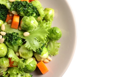 Photo of Plate of salad with Brussels sprouts isolated on white, closeup